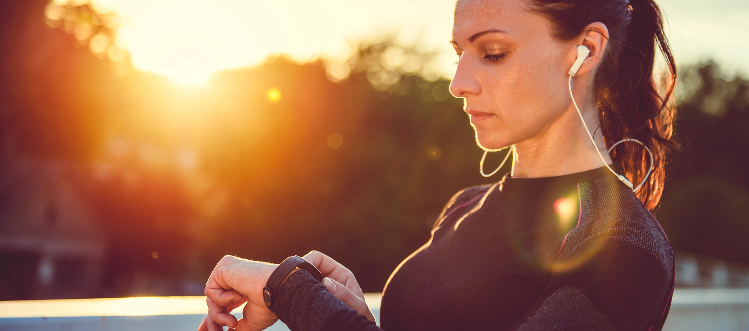 Woman checking her fitness tracker data after a workout, looking for reassurance in the numbers